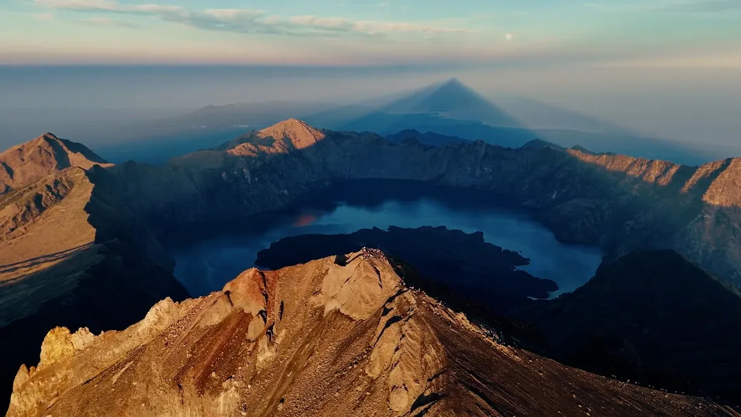 The Rinjani caldera and Segara Anak lake seen from the crater rim at dawn